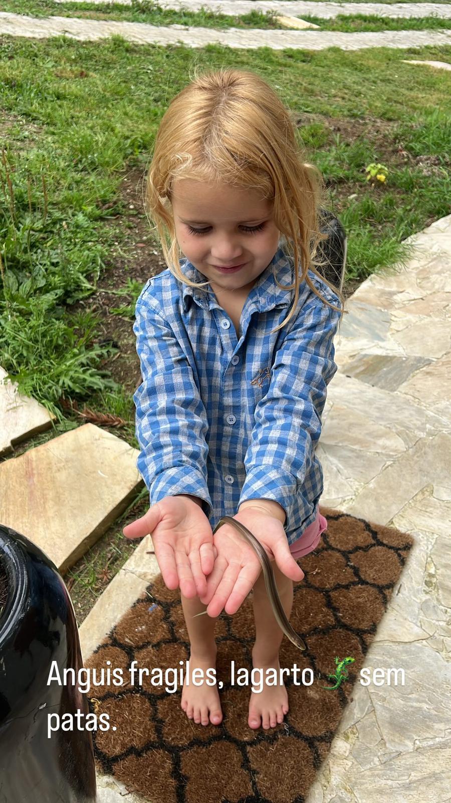 Trinity holding a legless lizard